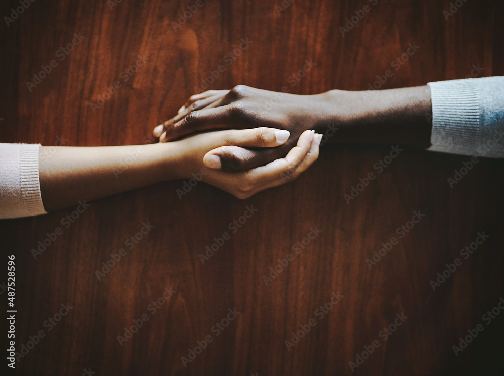 Youll always have someone who cares. High angle shot of two people holding hands in comfort.