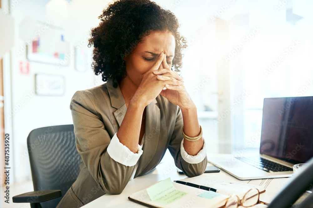 The pressure at work is getting too much. Cropped shot of a businesswoman suffering from a headache.