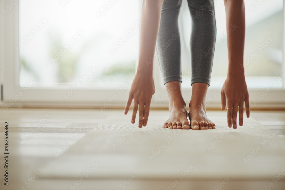 Yoga can always be modified to fit peoples needs. Cropped shot of a young woman practicing yoga at h