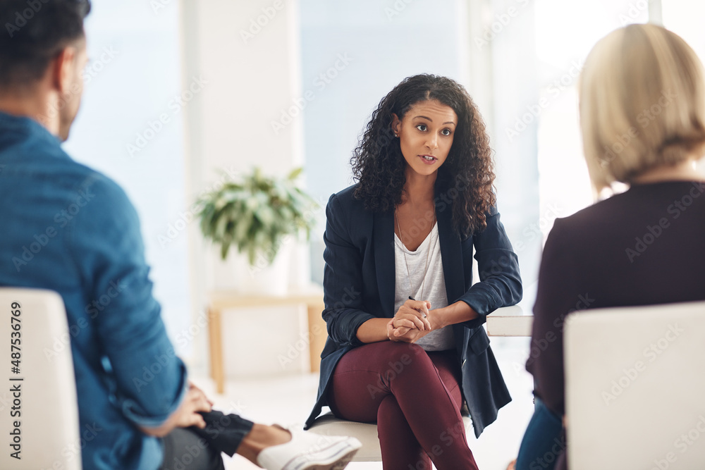 And how does that make you feel. Shot of a young therapist speaking to a couple during a counseling 