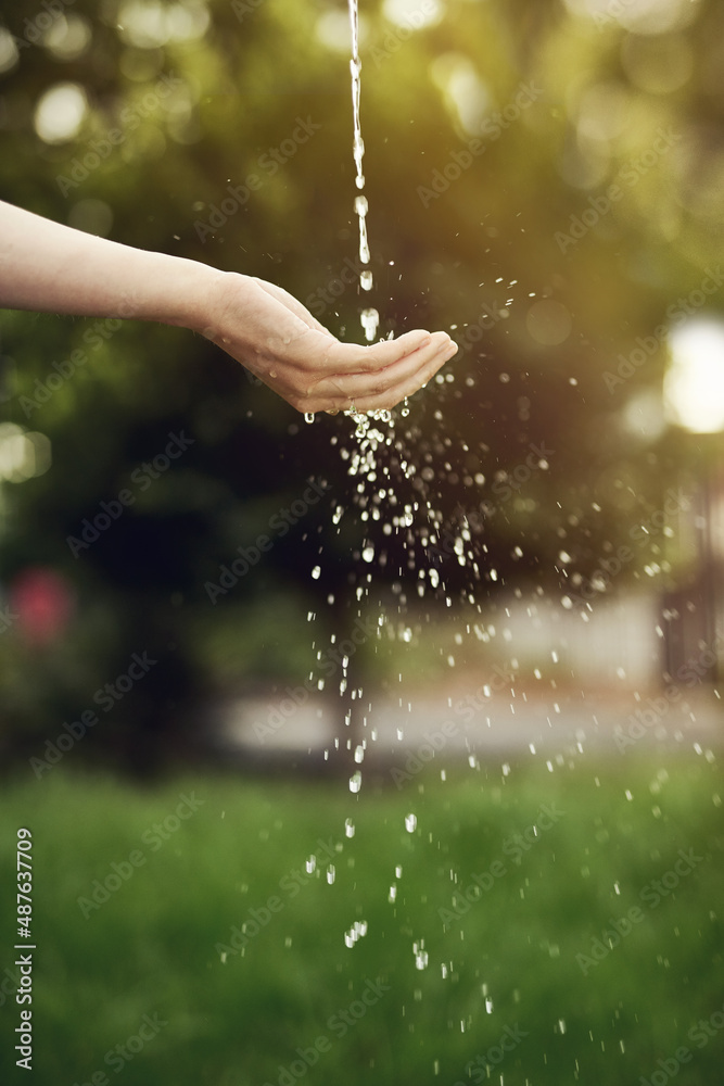 Water is life, dont waste it. Cropped shot of water running on a womans hand outside.