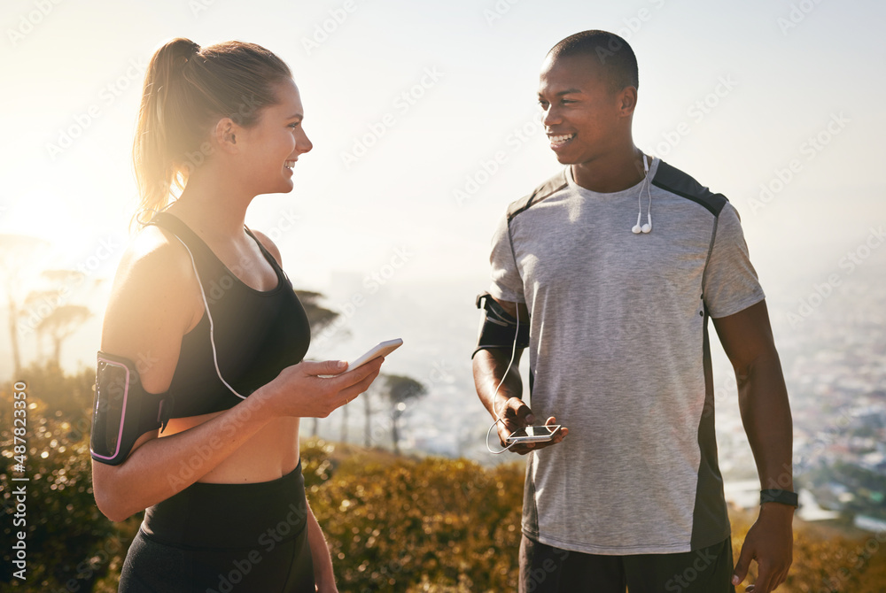 Have you got your running playlist ready. Shot of a fit young couple working out together outdoors.