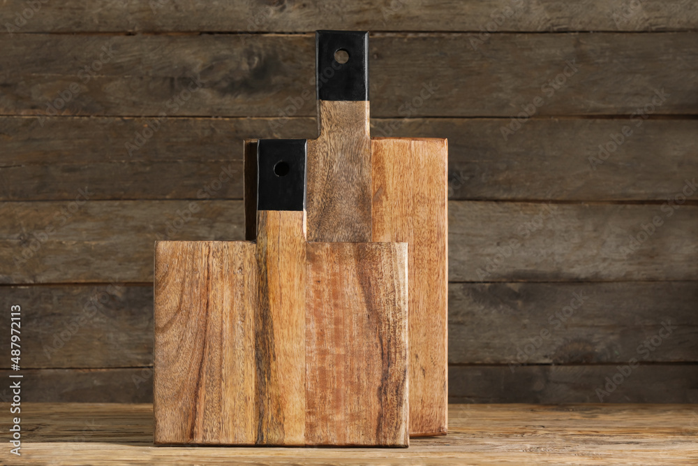 Cutting boards on wooden background