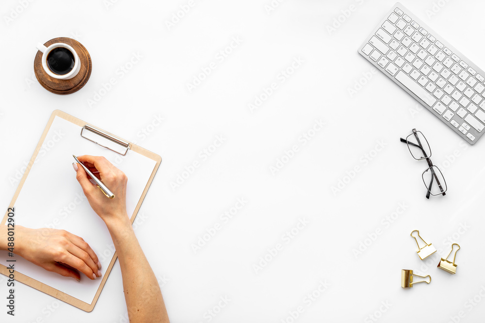 Woman hands working with computer on office table, top view