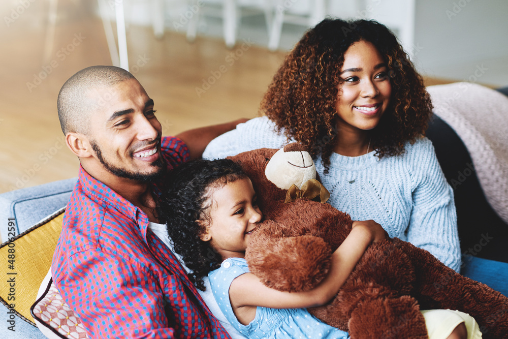 Family time is happiness time. Cropped shot of a happy young family of three relaxing together in th