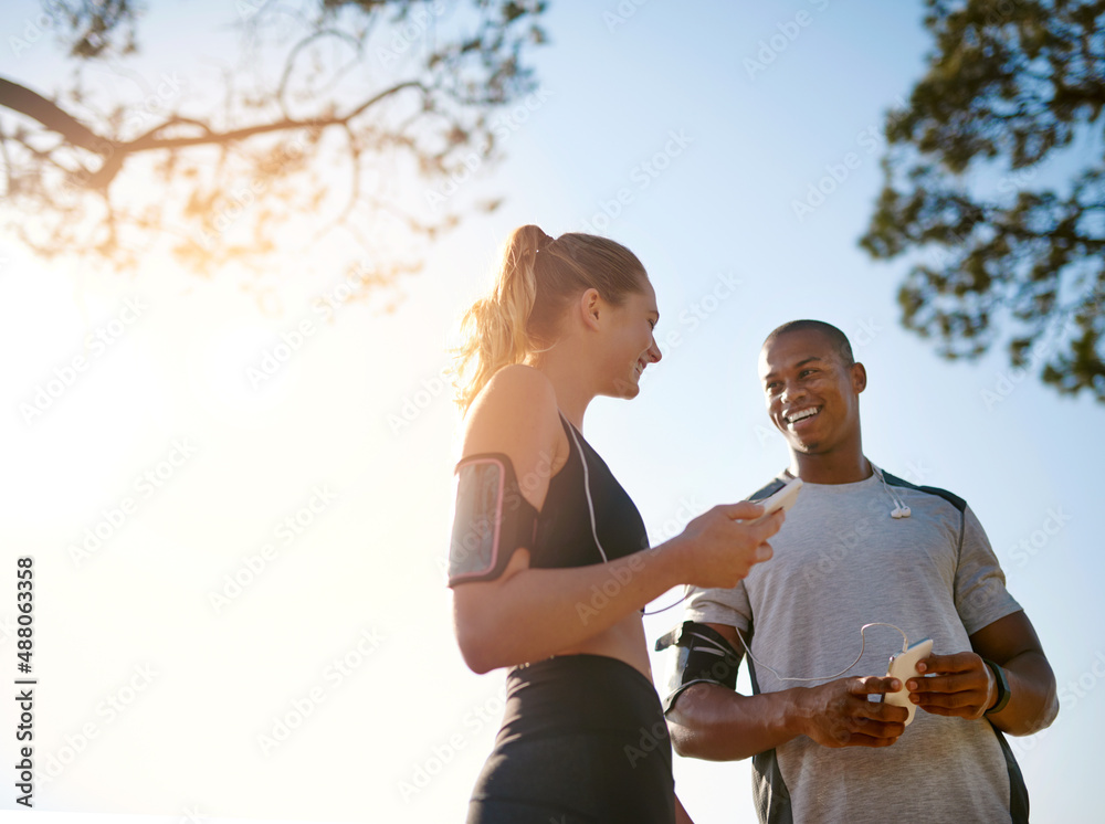 Buddy up for the best. Shot of a fit young couple working out together outdoors.