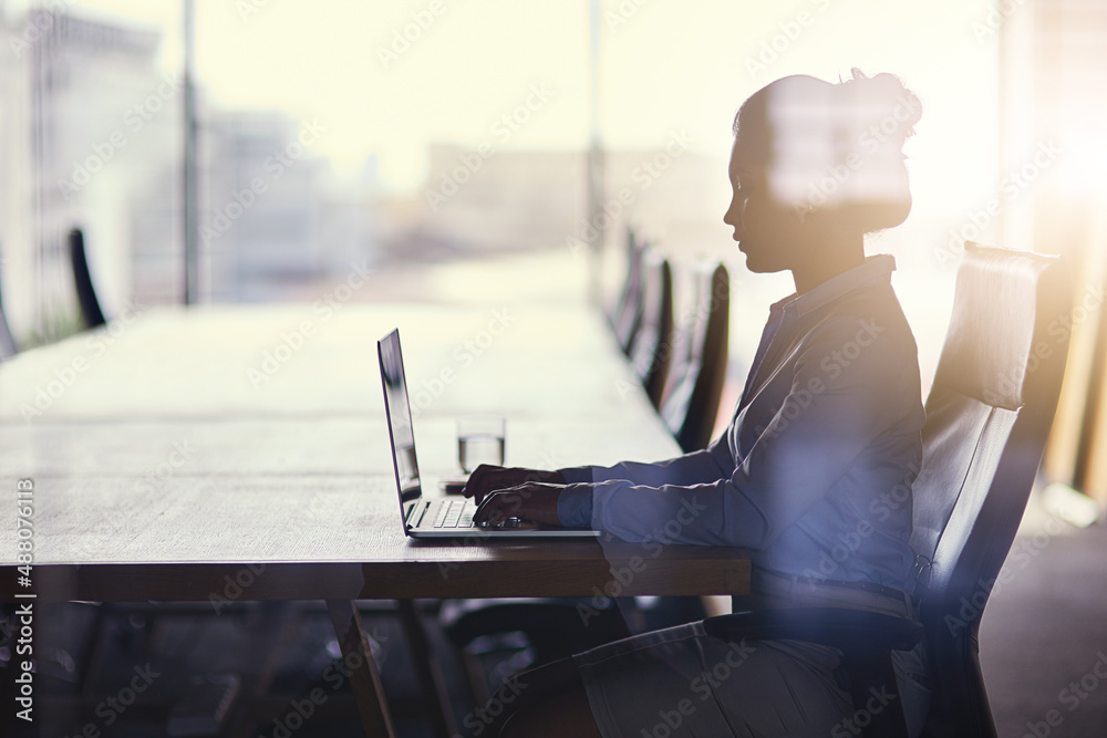 Getting straight down to business. Cropped shot of a businesswoman working on her laptop in the offi