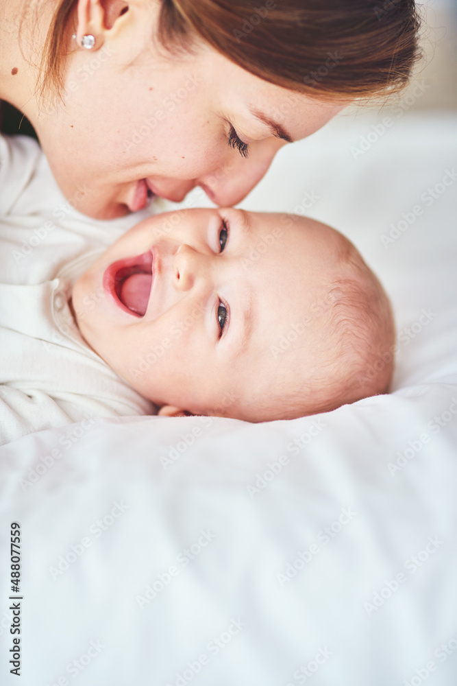 That tickles, Mom. Shot of a young mother bonding with her adorable baby boy at home.