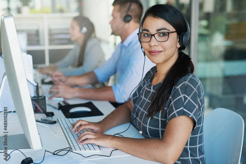 Your call is important to us. Portrait of a happy and confident young woman working in a call center