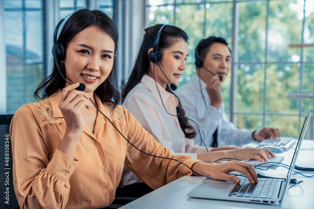 Business people wearing headset working actively in office . Call center, telemarketing, customer su