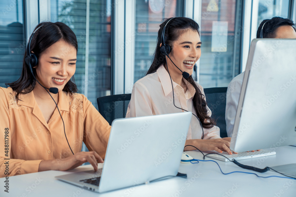 Business people wearing headset working actively in office . Call center, telemarketing, customer su