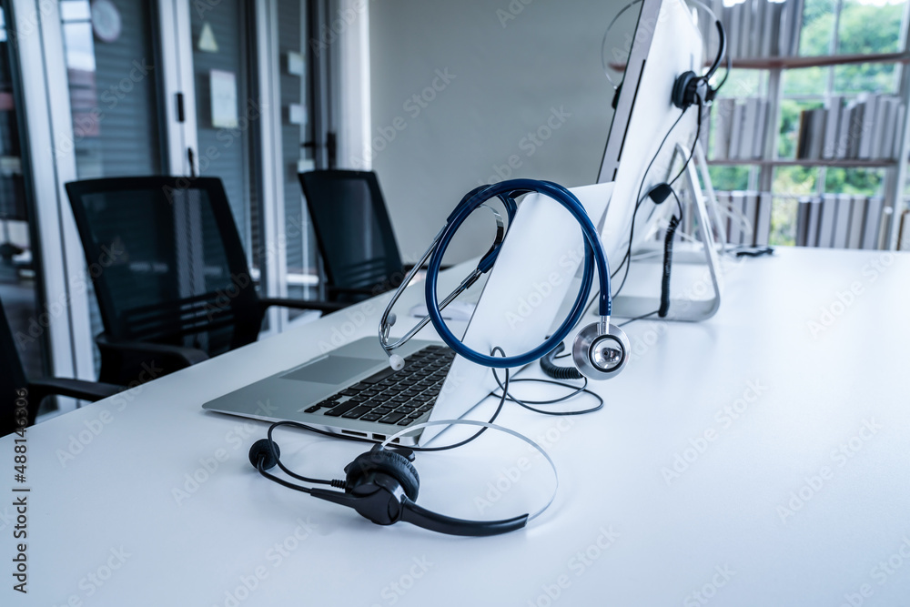 Headset and doctor equipment at clinic ready for actively support for patient by online video call .