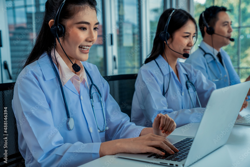 Doctor team wearing headset talking actively on video call in hospital clinic . Concept of telehealt