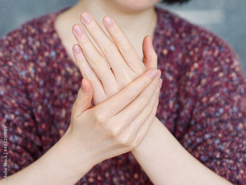 Close up of beautiful Woman Hands with blurry woman background. Female Hands Applying Cream Lotion. 