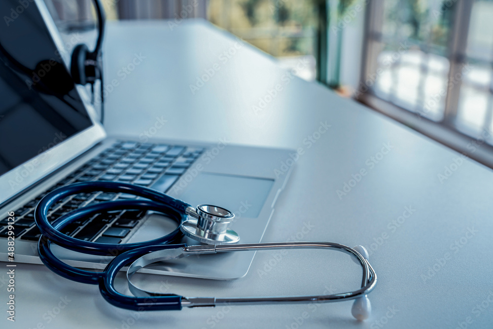 Headset and doctor equipment at clinic ready for actively support for patient by online video call .