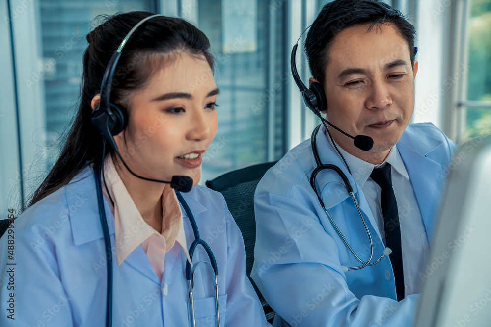 Doctor team wearing headset talking actively on video call in hospital clinic . Concept of telehealt