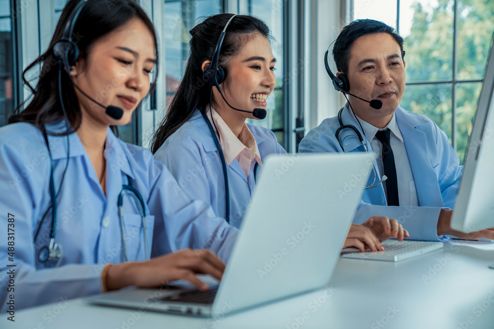 Doctor team wearing headset talking actively on video call in hospital clinic . Concept of telehealt