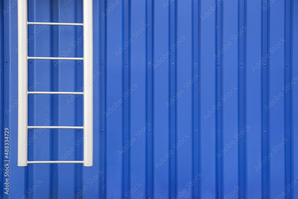 Fire escape metal ladder of blue building outdoors