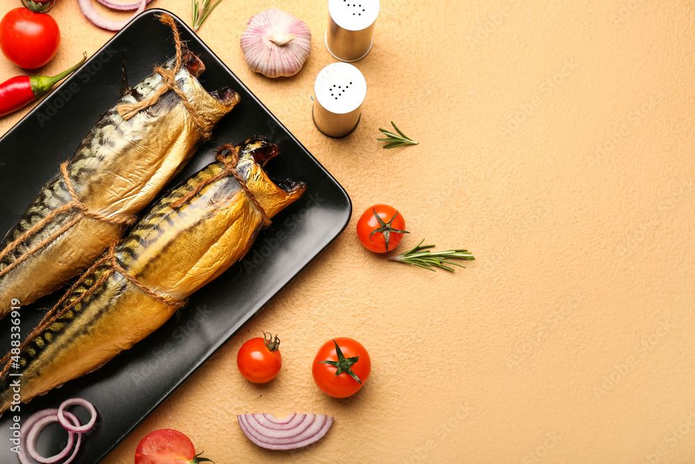 Plate with tasty smoked mackerel fishes and fresh vegetables on beige background