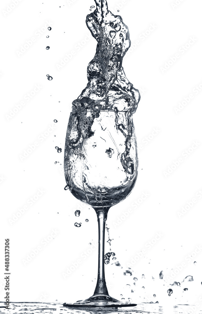 Glass of clean water with splash on white background