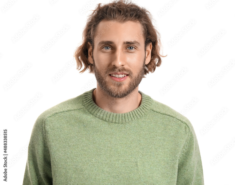 Handsome young man in knitted sweater on white background