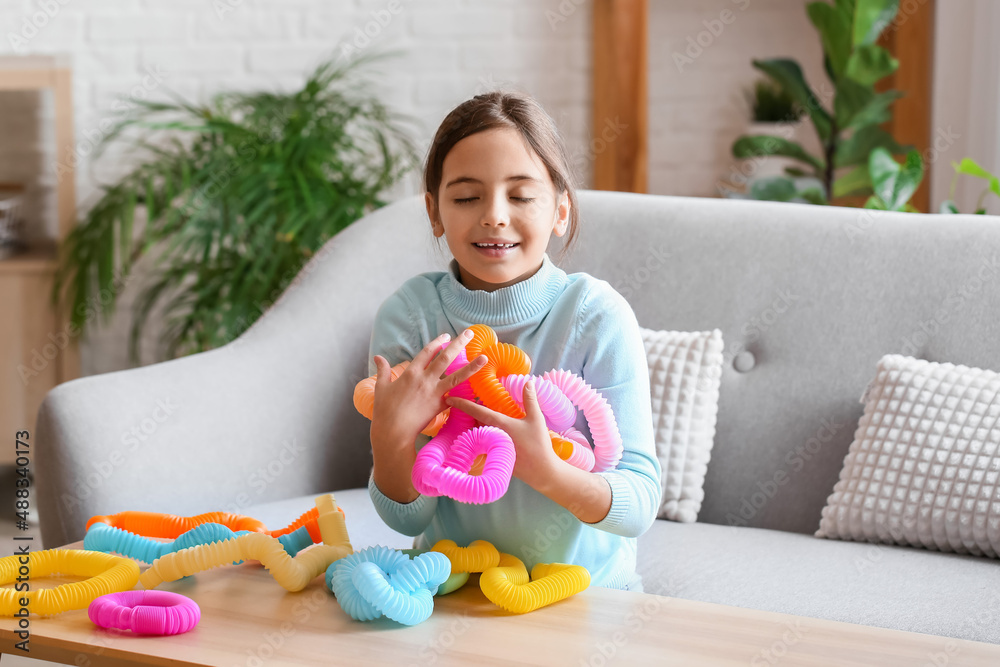 Little girl playing with Pop Tubes at home