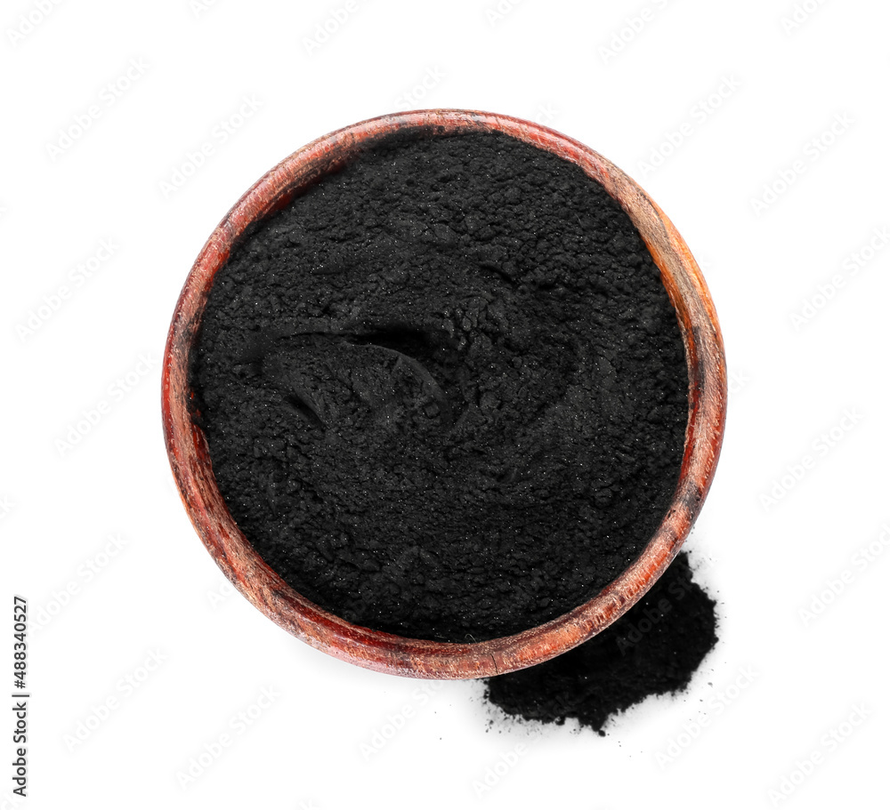 Bowl with activated charcoal tooth powder on white background