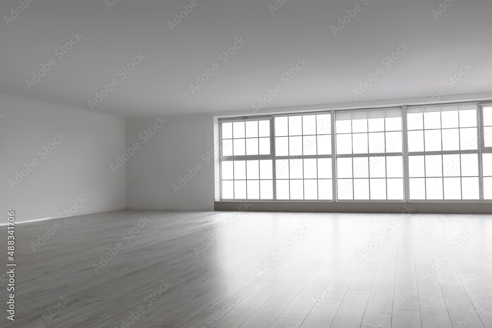 View of empty room with big windows and shelves