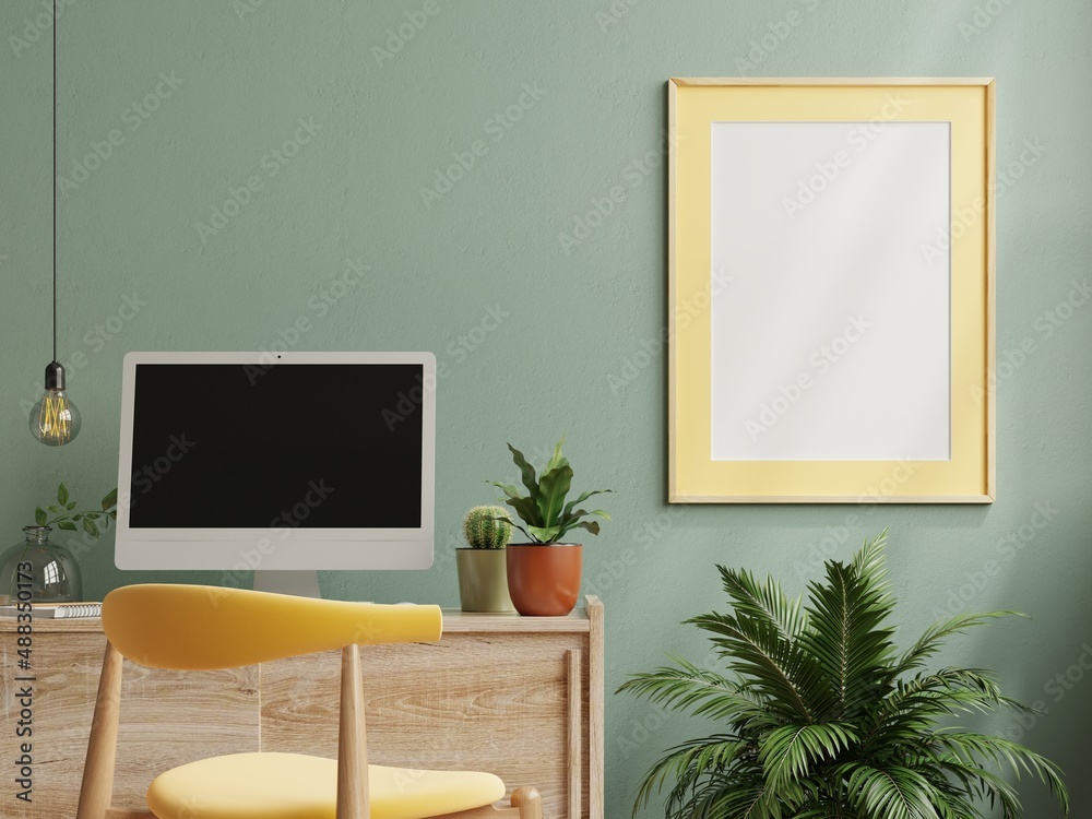 Mock up frame on work table in living room interior on empty green wall background.