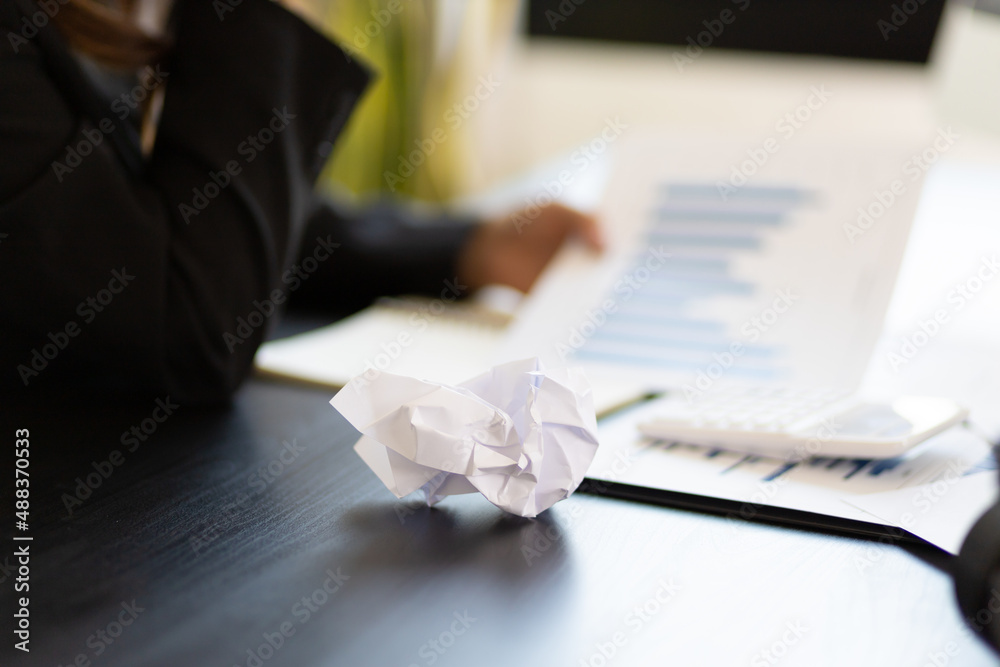 Waste paper on the desk in the office. Failed work concepts and work mistakes.