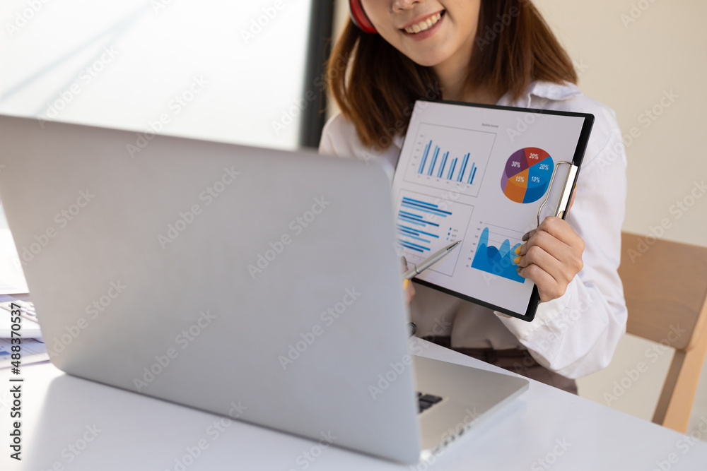 Woman working on laptop and giving presentations while online meeting. Work from home concept.