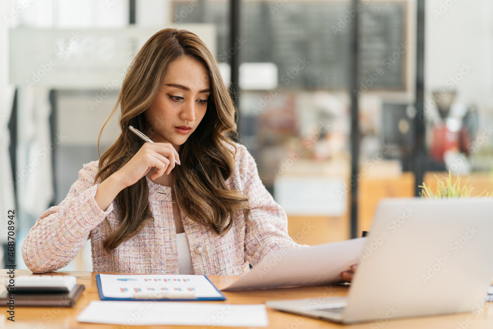 Portrait of smiling beautiful business asian woman with working in modern office desk using computer