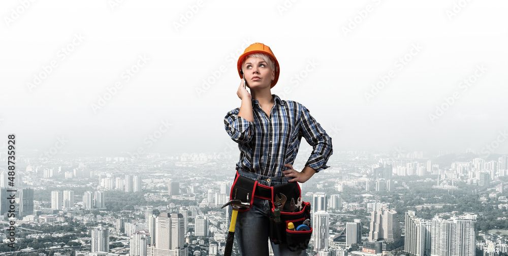 Attractive woman in workwear and hardhat