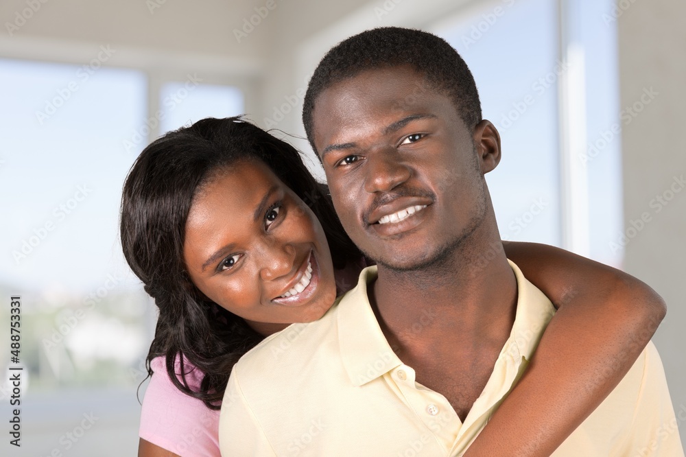 Portrait Of Happy Young couple Embracing In Interior, Loving Having Fun Together