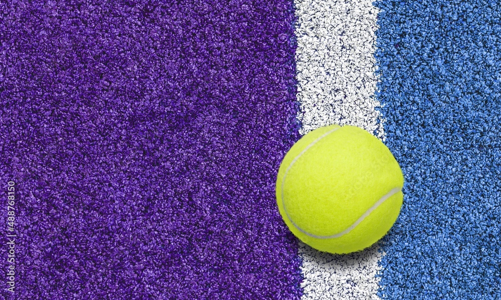 Padel classic yellow ball on a blue court