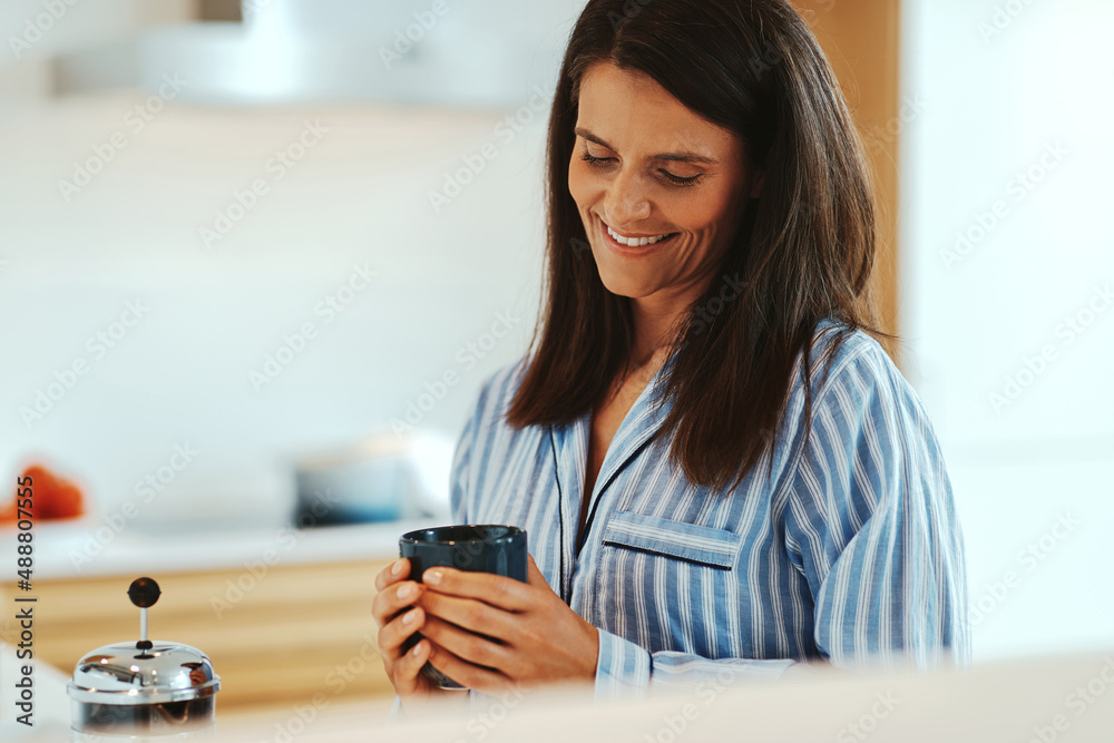 Smiling woman drinking coffee in the morning