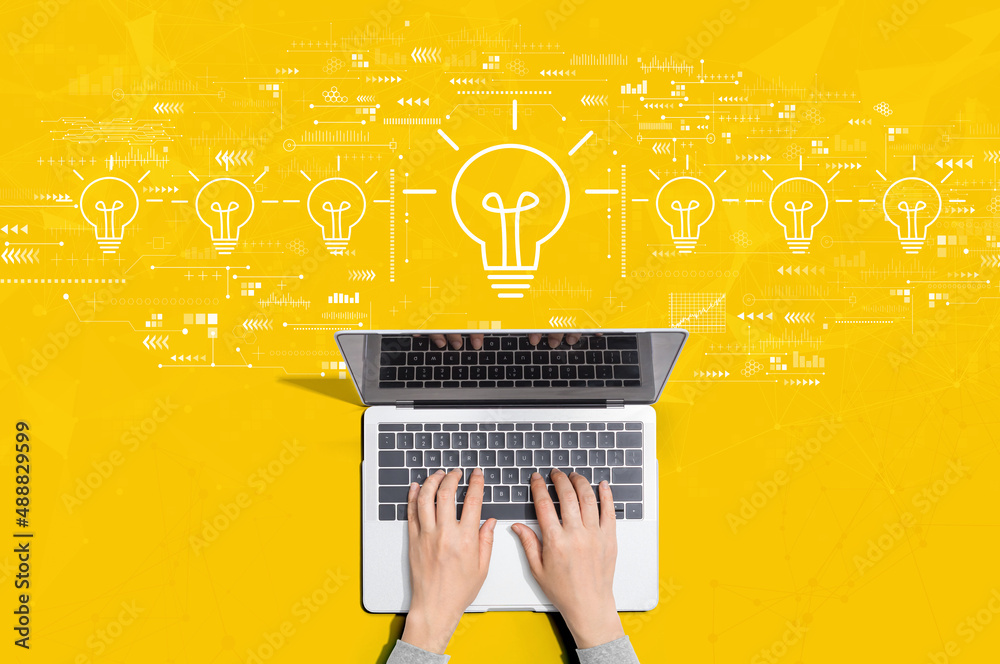 Idea light bulb theme with person using a laptop computer