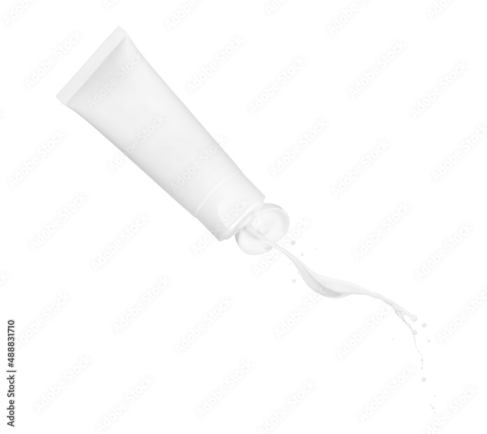 Cream pours out of the tube in the air on a white background