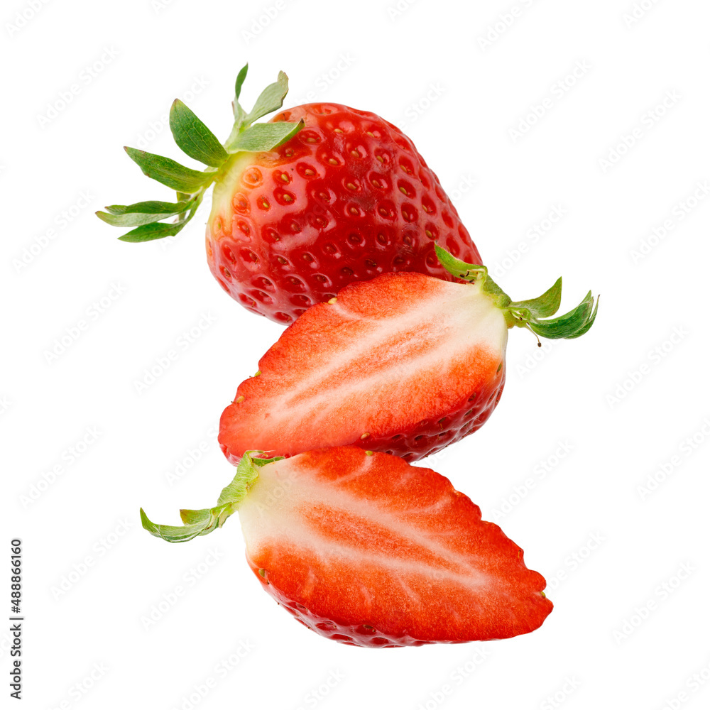 Fresh sweet whole and sliced strawberry closeup flying isolated on a white background.