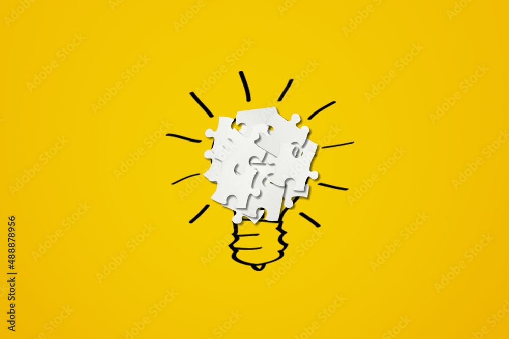 Light bulb from puzzles on background. Inspiration and creative idea concept.