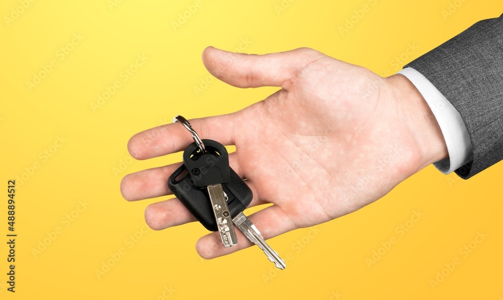 Hand showing giving car key as gift