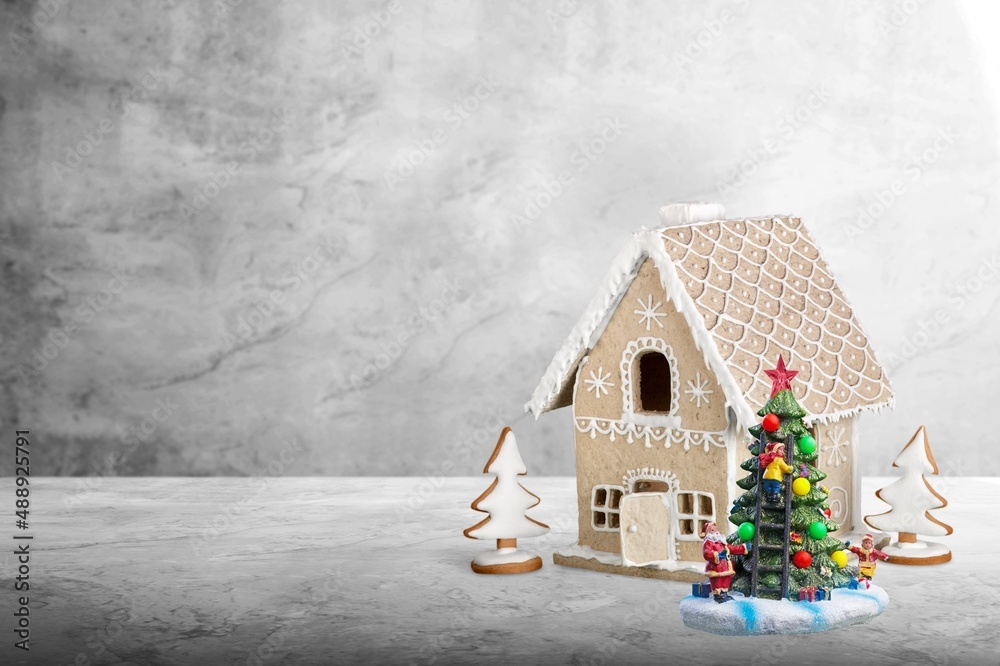 Christmas table decoration with toy house and christmas trees. Festive interior design