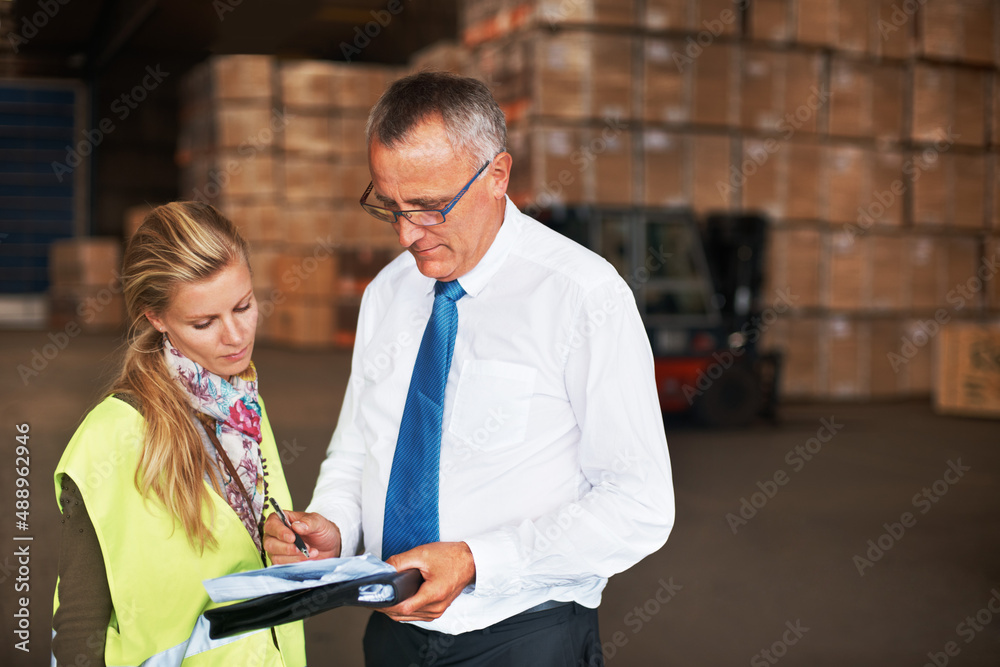 Your copyspace will fit in here perfectly. Two colleagues talking to one another in a warehouse fill