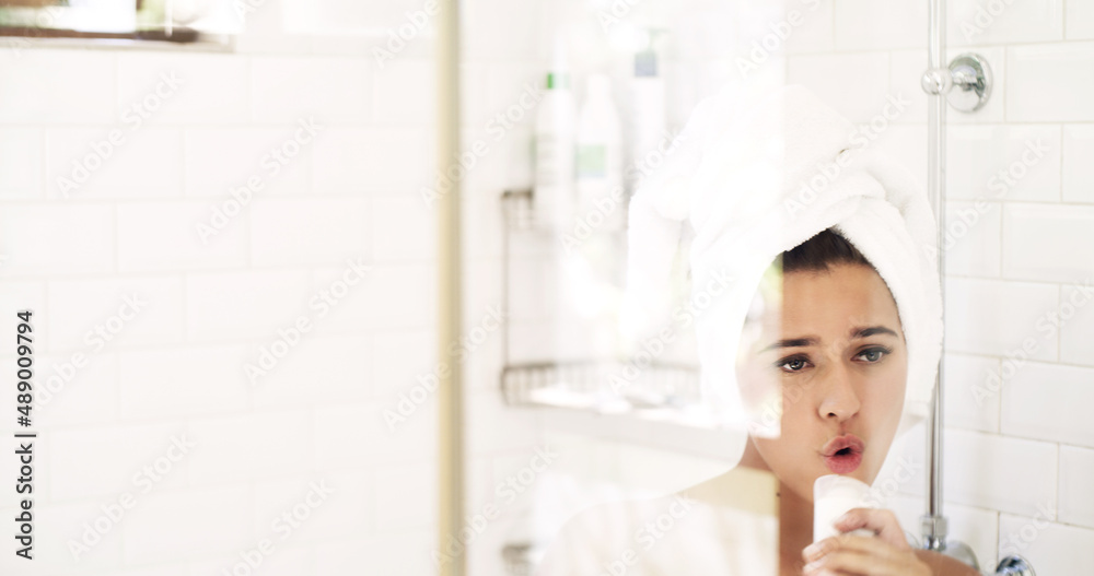 Time to debut a new you. Shot of an attractive young woman singing while going through her morning b