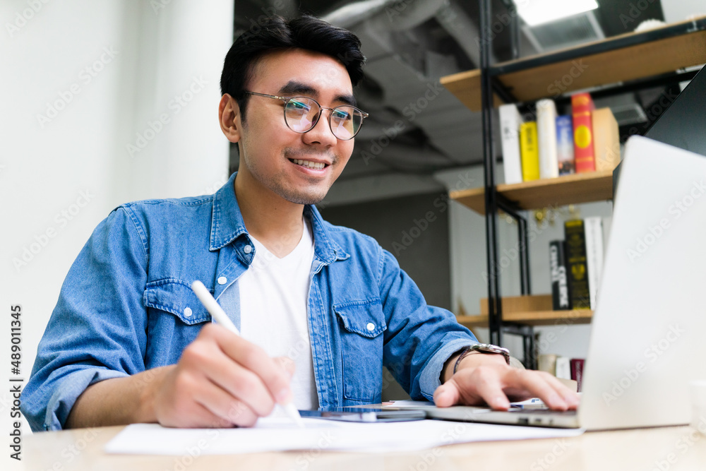 Young Asian man working at office