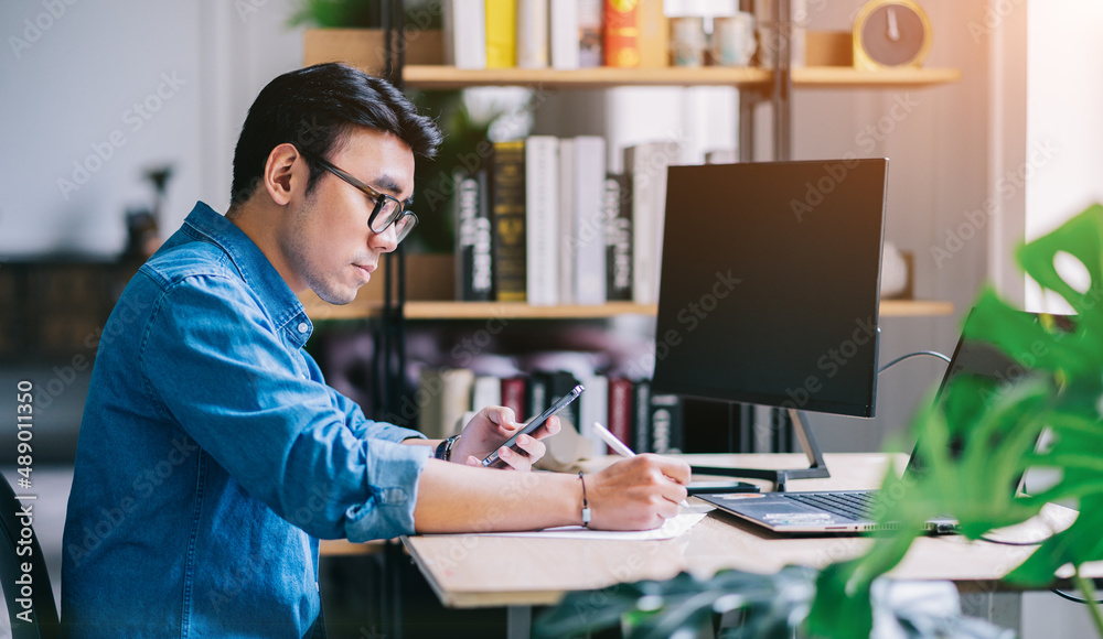 Young Asian man working at office