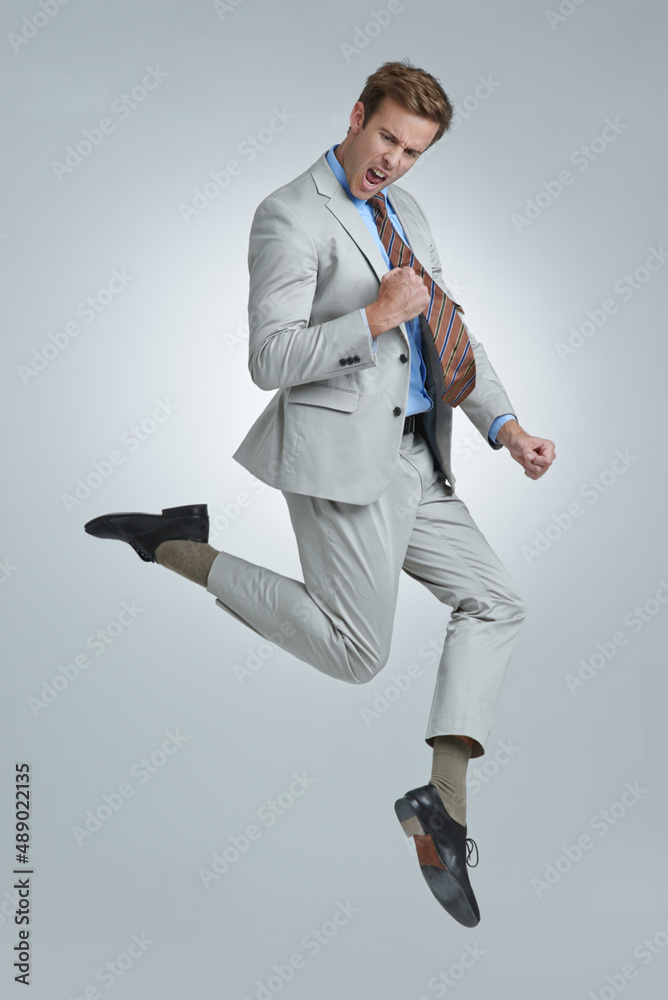 Oh yeah. Shot of a young businessman wildly celebrating his success.