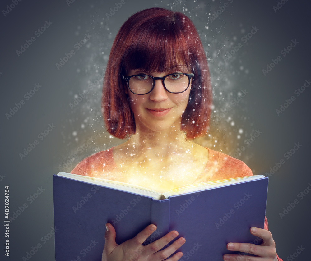 Open a book...and begin the journey. A cropped shot of a young adult reading a book with glowing pag