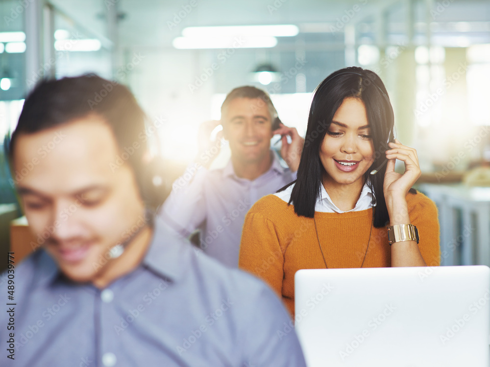 Helping her clients with a smile. Cropped shot of people working in their office.