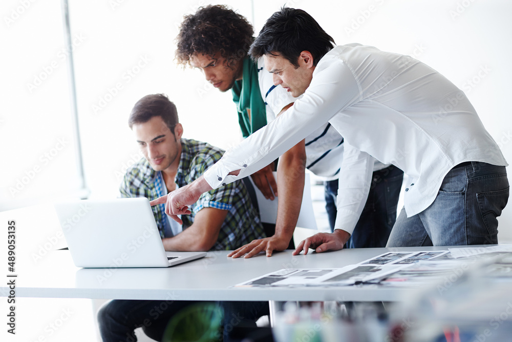 What is that. Three male coworkers working in the office together.